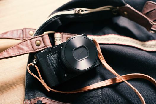 closeup vintage style of digital mirrorless camera with leather strap.