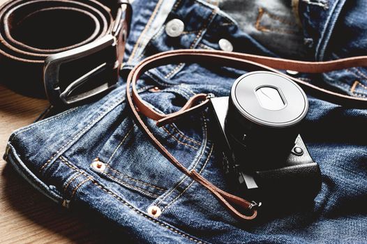 vintage style of digital mirrorless camera with leather strap with men's accessories and gadgets