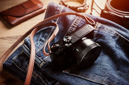 closeup vintage style of digital mirrorless camera with leather strap.
