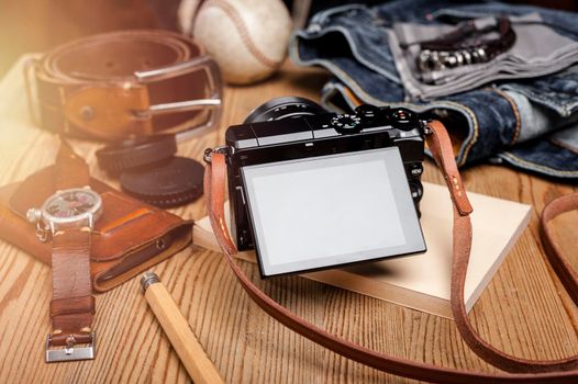 closeup blank screen of digital mirrorless camera with leather strap.