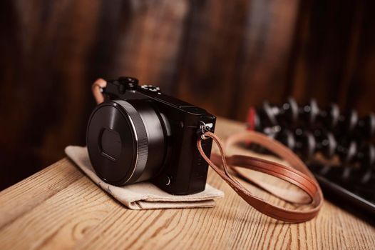 vintage style of digital mirrorless camera with leather strap