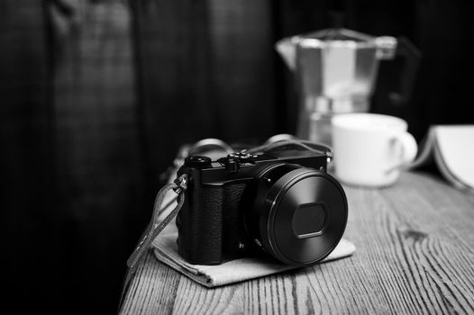 vintage style of digital mirrorless camera with leather strap in black and white