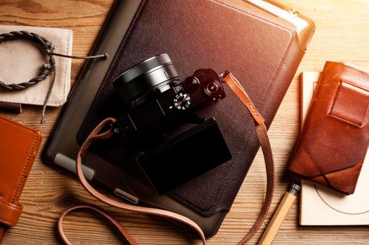 vintage style of digital mirrorless camera with leather strap with men's accessories and gadgets