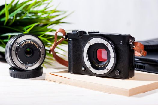 closeup vintage style of digital mirrorless camera with leather strap.