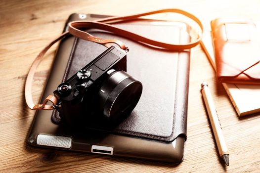 vintage style of digital mirrorless camera with leather strap with men's accessories and gadgets