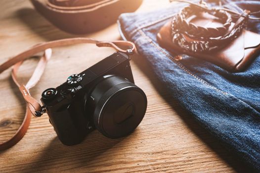 vintage style of digital mirrorless camera with leather strap with men's accessories and gadgets