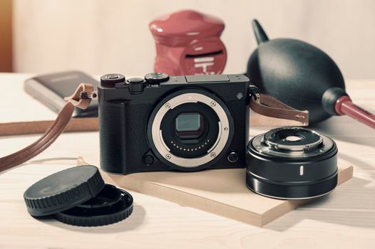 closeup vintage style of digital mirrorless camera with cleaning kits