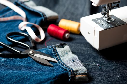 sewing indigo denim jeans with sewing machine, garment industrial concept.