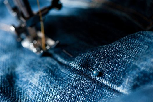 sewing indigo denim jeans with sewing machine, garment industrial concept.