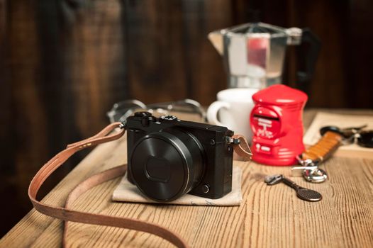 vintage style of digital mirrorless camera with leather strap