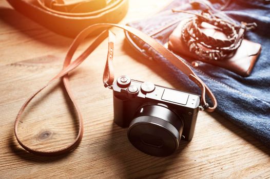 vintage style of digital mirrorless camera with leather strap with men's accessories and gadgets