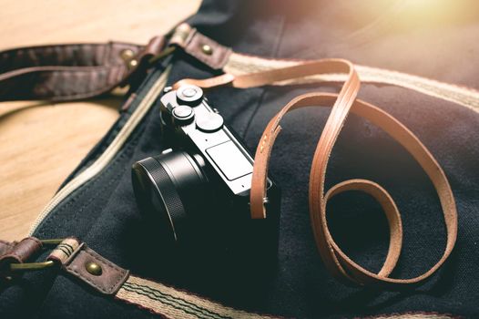 closeup vintage style of digital mirrorless camera with leather strap.