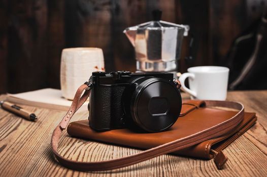 closeup vintage style of digital mirrorless camera with leather strap.