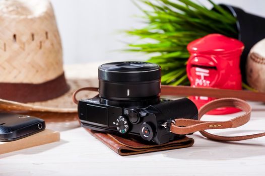 closeup vintage style of digital mirrorless camera with leather strap.