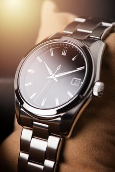 closeup luxury automatic wristwatch for men with black dial and stainless steel bracelet.