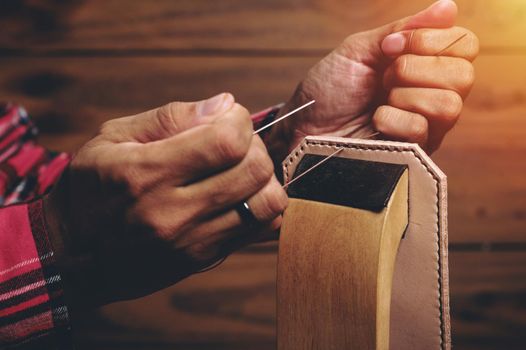 Sewing the vegetable tanned leather by hand. Leather and the craft tools.