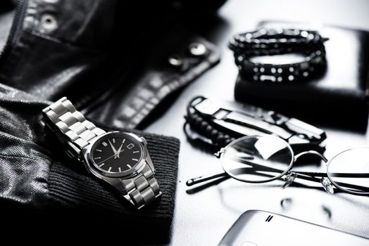 closeup luxury automatic wristwatch for men with black dial and stainless steel bracelet.