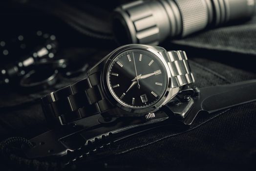 closeup luxury automatic wristwatch for men with black dial and stainless steel bracelet.