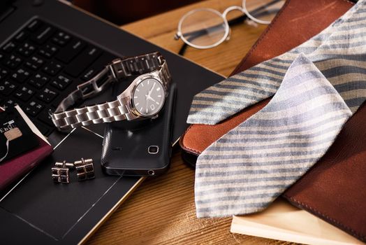 men's accessories, closeup at the luxury automatic wristwatch with black dial and stainless steel bracelet.