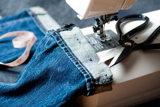 sewing indigo denim jeans with sewing machine, garment industrial concept.