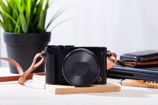 closeup vintage style of digital mirrorless camera with leather strap.