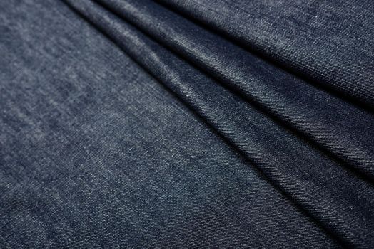 closeup indigo denim fabric texture, material for jeans and other garment.