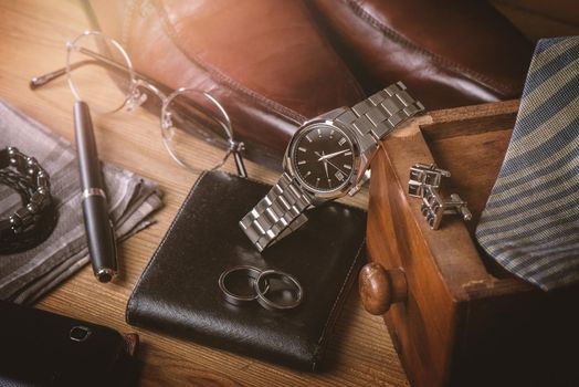 men's accessories, closeup at the luxury automatic wristwatch with black dial and stainless steel bracelet.