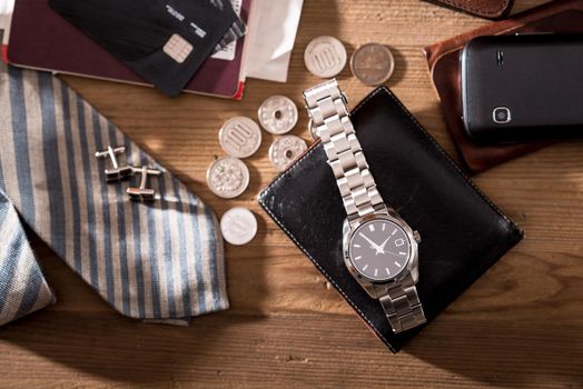 men's accessories, closeup at the luxury automatic wristwatch with black dial and stainless steel bracelet.