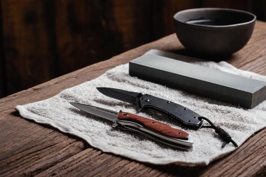 Sharpen the pocket knife with grindstone or whetstone. Pocket knife care and maintenance.