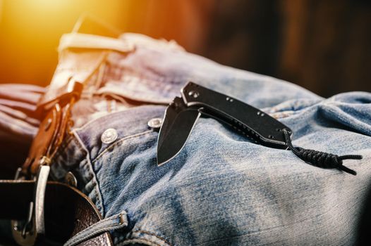 Pocketknife with old jeans in the background, pocketknife is one of every day carry (EDC) item for men.