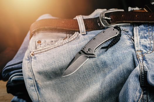 Pocketknife with old jeans in the background, pocketknife is one of every day carry (EDC) item for men.
