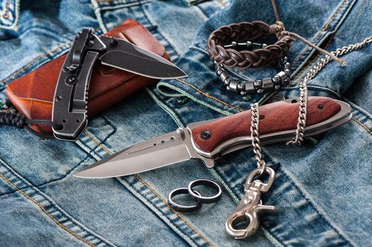 stainless steel folding knife with wooden handle and other everyday carry (EDC) items for men. closeup at folding knife. 