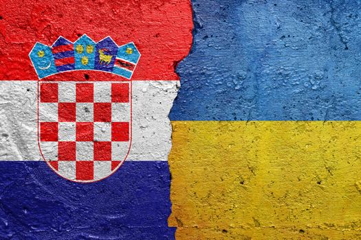 Croatia and Ukraine - Cracked concrete wall painted with a Croatian flag on the left and a Ukrainian flag on the right