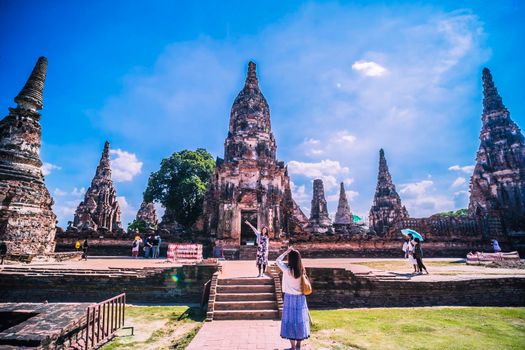 November 2019 ,Ayutthya Thailand . Young Tourist Asian woman walking in the Ayutthaya Historical Park. Asian girl walking take a picture at Ayutthaya Historical Park