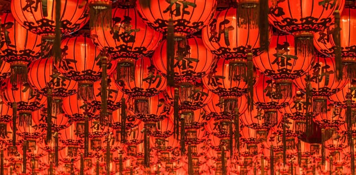 Chinese red lanterns hanging in street at night for decoration. Chinese letter written mean good luck.