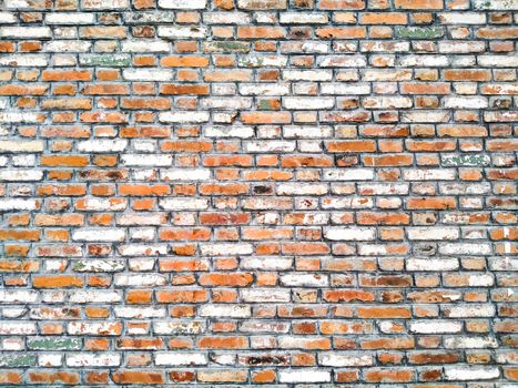 Orange Random Brick Glass & Resin Mesh Mounted Mosaic Tiles creates a beautiful multi-dimensional effect. Old-fashioned brick building. Background of random orange green tone brick wall, pattern, close