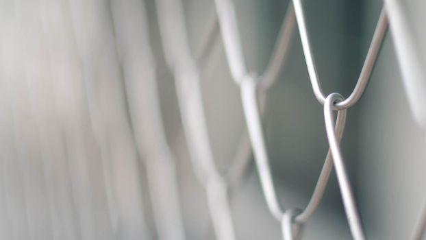 Close up Solid Metallic Wire Mesh Chain link Fence in Vintage Style Steel. Selective focus wire mesh fence