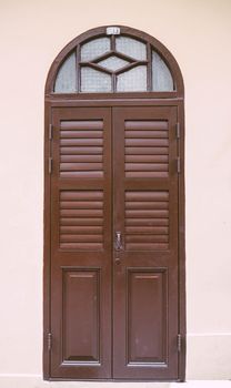 Vintage arched shutters, two panel rustic Mediterranean Shutter. Old wooden vintage louver window. Blinds Window Shutter Plantation Shutter in brown.