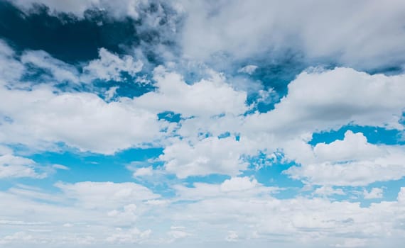 Blue sky white fluffy clouds background. Beautiful blue sky and white cumulus clouds abstract background. Cloudscape background. Blue sky and fluffy white clouds on sunny.