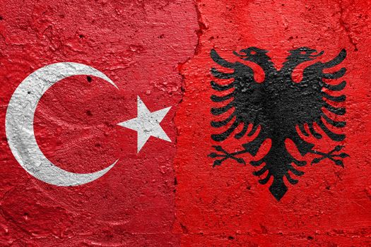 Turkey and Albania - Cracked concrete wall painted with a Turkish flag on the left and a Bosnian flag on the right