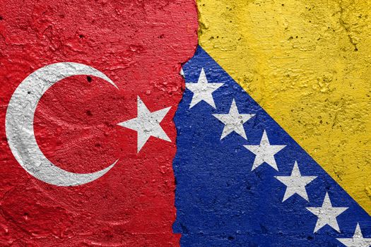 Turkey and Bosnia and Herzegovina - Cracked concrete wall painted with a Turkish flag on the left and a Bosnian flag on the right