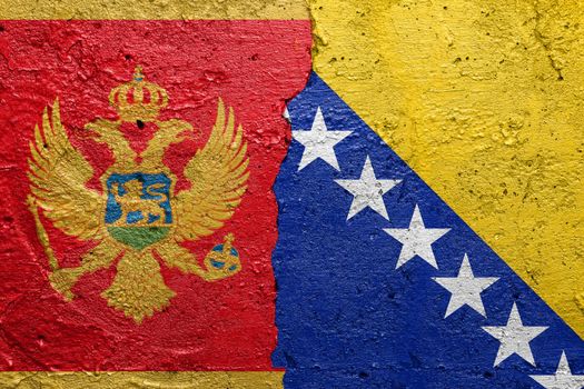 Montenegro and Bosnia and Herzegovina - Cracked concrete wall painted with a Montenegrin flag on the left and a Bosnian flag on the right