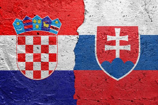 Croatia and Slovakia - Cracked concrete wall painted with a Croatian flag on the left and a Slovakian flag on the right