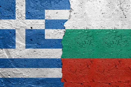 Greece and Bulgaria - Cracked concrete wall painted with a Greek flag on the left and a Bulgarian flag on the right