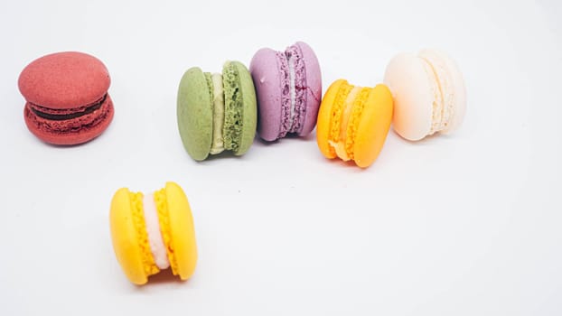 Pastel colored macarons sweet French dessert isolated on white background.