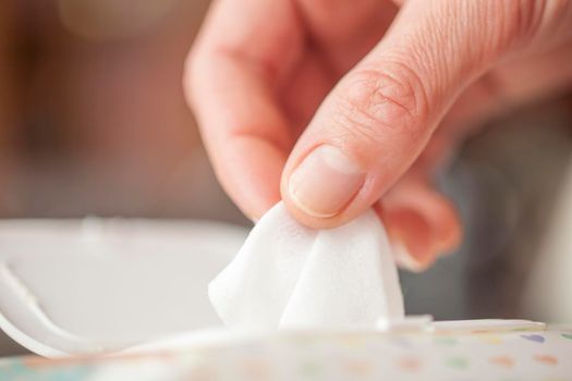 Hand picked a wet wipes in package box, Wet wipes in a woman's hand