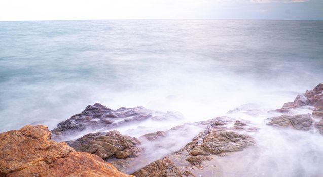 Long Exposure of Sea with Smooth Wave and Rock. Nature of Seascape abstract vacation travel in summer time.