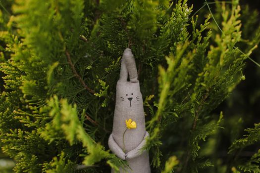 Eco-friendly cute handmade toy on grass at sunny summer day