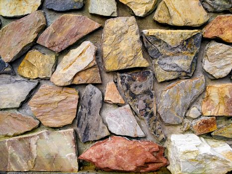 Stone wall texture pattern abstract background in earth tone. Material for architecture and interior decoration.