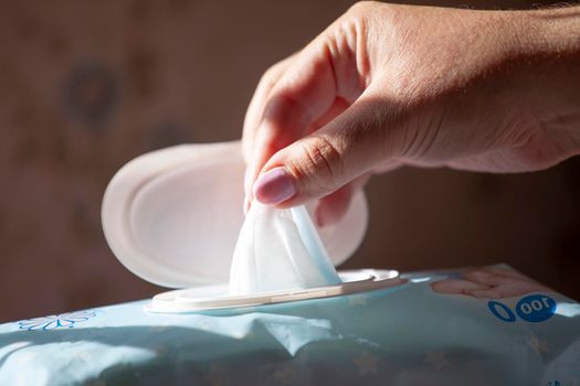 Hand picked a wet wipes in package box, Wet wipes in a woman's hand